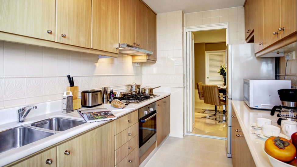 fully equipped kitchen of three bedroom grand holiday apartments singapore
