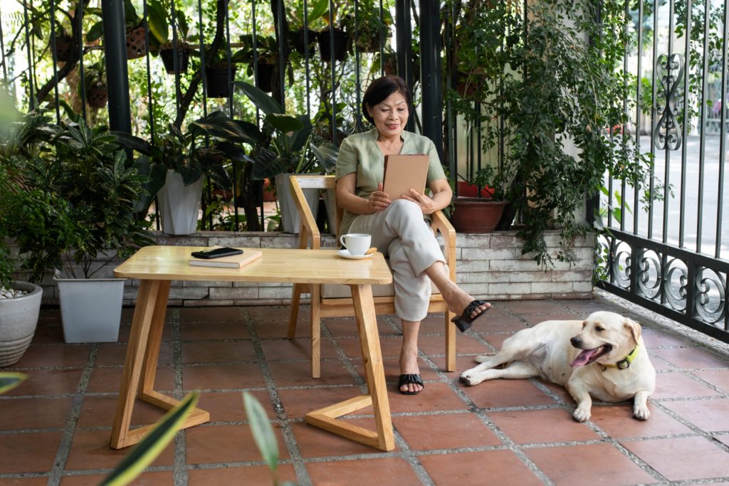 woman sitting with pet dog